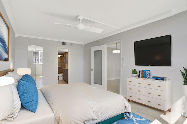 tiled bedroom featuring ceiling fan, ornamental molding, and ensuite bath