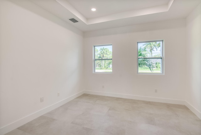 unfurnished room with a raised ceiling