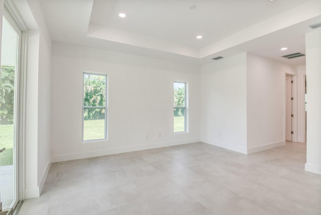 spare room featuring a raised ceiling