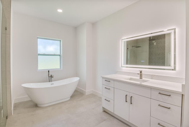 bathroom featuring vanity and independent shower and bath