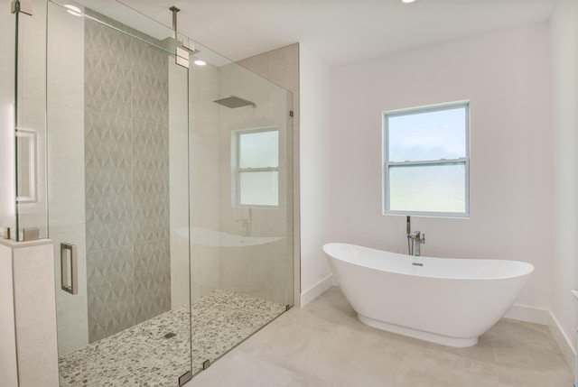 bathroom with tile patterned flooring and separate shower and tub