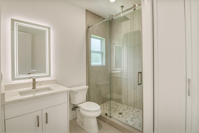 bathroom with tile patterned floors, an enclosed shower, toilet, and vanity