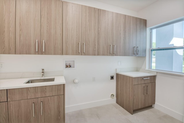 laundry area with washer hookup, cabinets, gas dryer hookup, hookup for an electric dryer, and sink