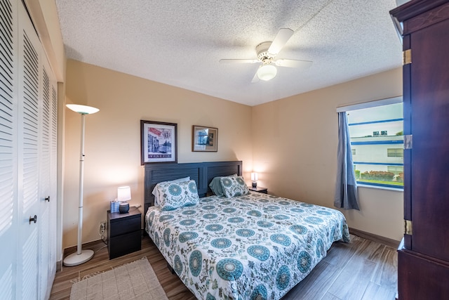 bedroom featuring ceiling fan, a closet, and dark wood-type flooring