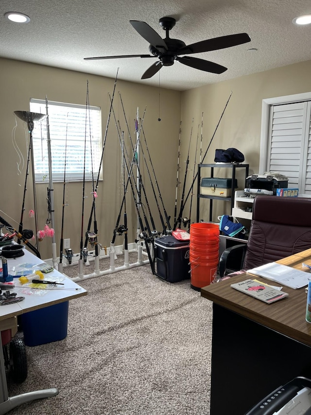 miscellaneous room featuring carpet floors, ceiling fan, and a textured ceiling