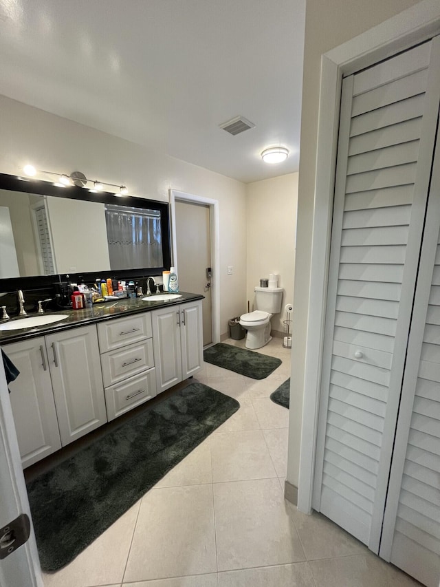 bathroom with tile patterned floors, vanity, a bidet, and toilet