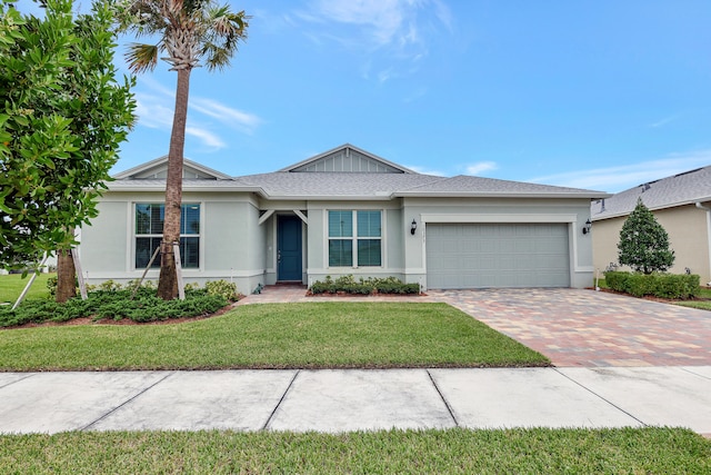 single story home featuring a garage and a front yard