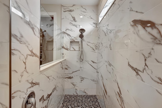 bathroom with a tile shower