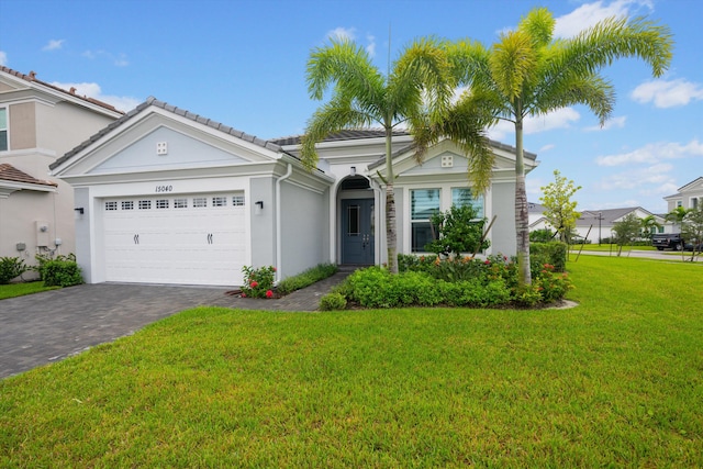 view of front of home featuring a front yard and a garage