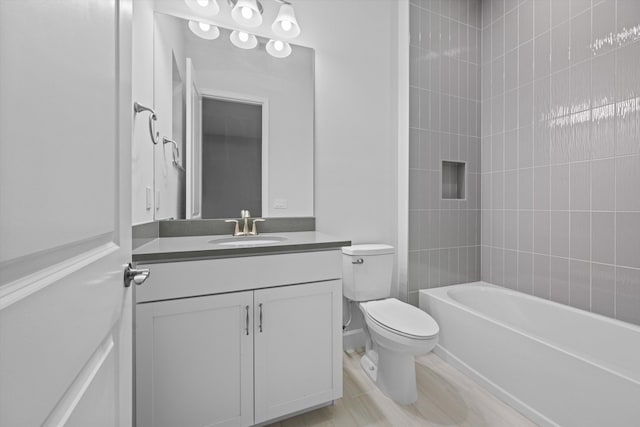 full bathroom with vanity, tiled shower / bath combo, and toilet