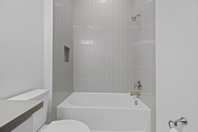 full bathroom featuring vanity, toilet, and tiled shower / bath