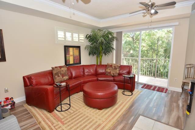 living room with ceiling fan, wood-type flooring, and ornamental molding