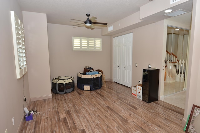 miscellaneous room with light hardwood / wood-style flooring and ceiling fan