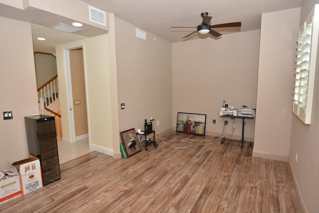 spare room with light wood-type flooring and ceiling fan