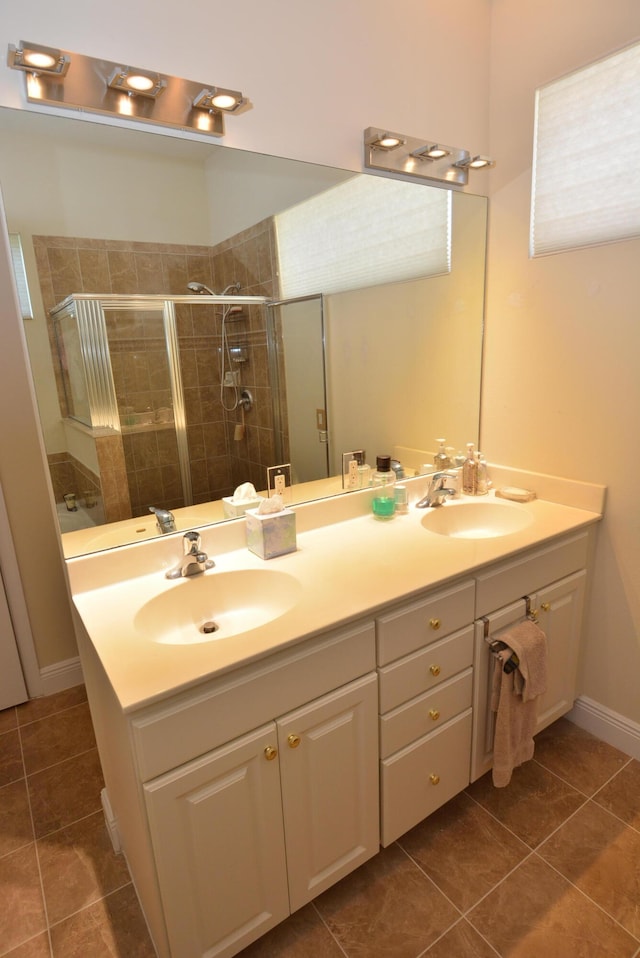 bathroom featuring tile patterned floors, vanity, and an enclosed shower