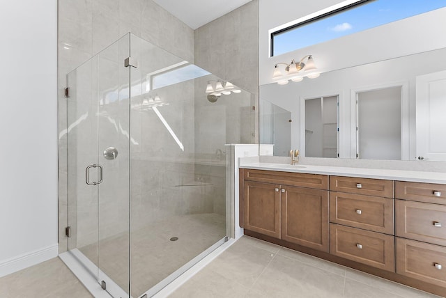 bathroom with vanity, a shower with shower door, and tile patterned floors