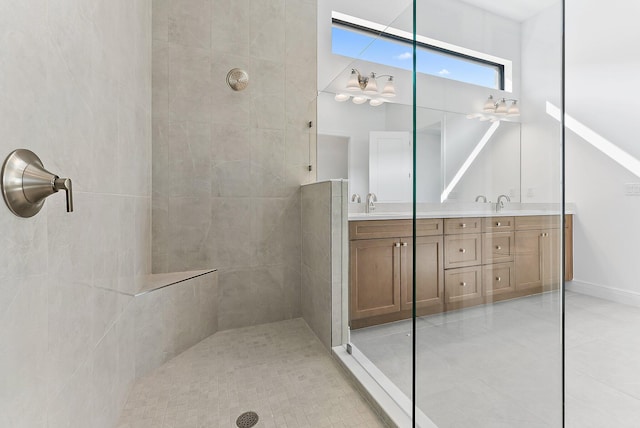 bathroom with vanity, tile patterned flooring, and a tile shower