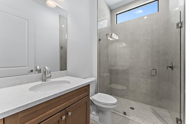 bathroom featuring vanity, toilet, and a shower with door