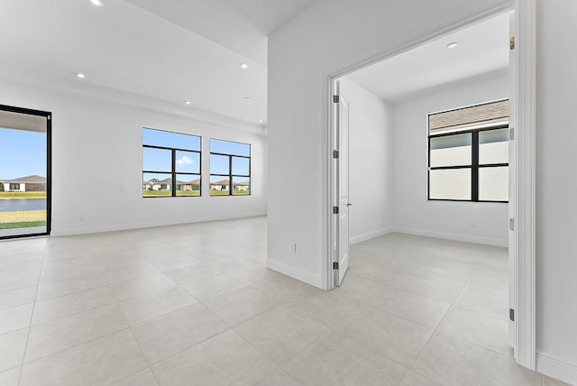 tiled spare room with a wealth of natural light