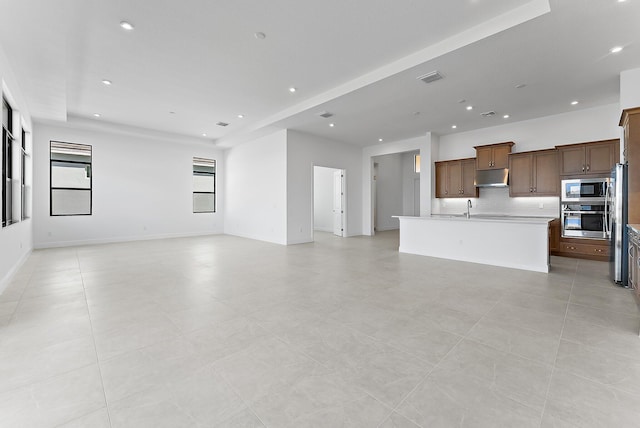 unfurnished living room with sink