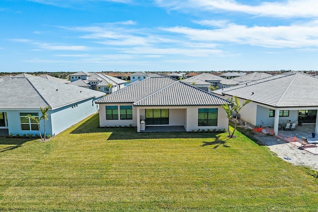 view of front of house with a patio and a front yard