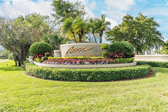 community sign featuring a lawn