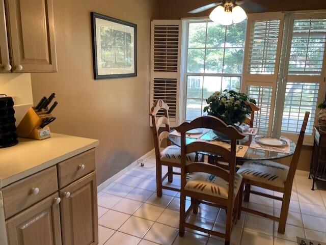 dining area featuring light tile patterned floors and ceiling fan