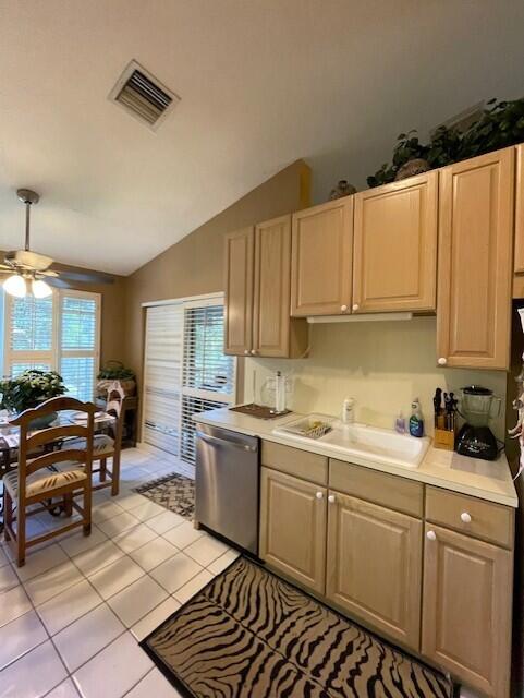 kitchen featuring dishwasher, light tile patterned floors, a wealth of natural light, and sink