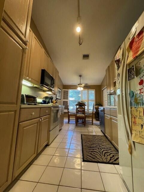 kitchen with lofted ceiling, white refrigerator with ice dispenser, ceiling fan, light tile patterned floors, and range