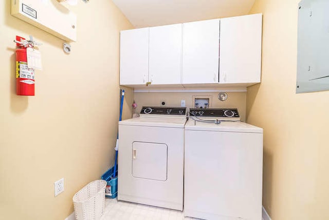 washroom with electric panel, cabinets, and washing machine and dryer