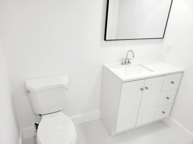 bathroom featuring vanity, tile patterned flooring, and toilet