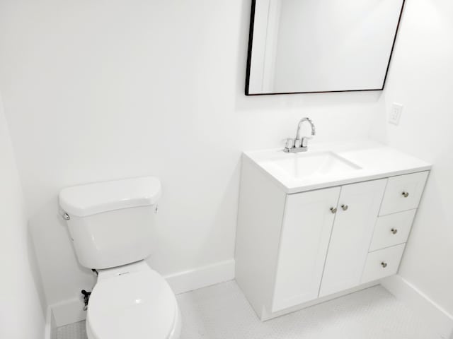 15 Burgundy Unit A, Delray Beach, FL 33484 - half bathroom with vanity, toilet, baseboards, and tile patterned flooring
