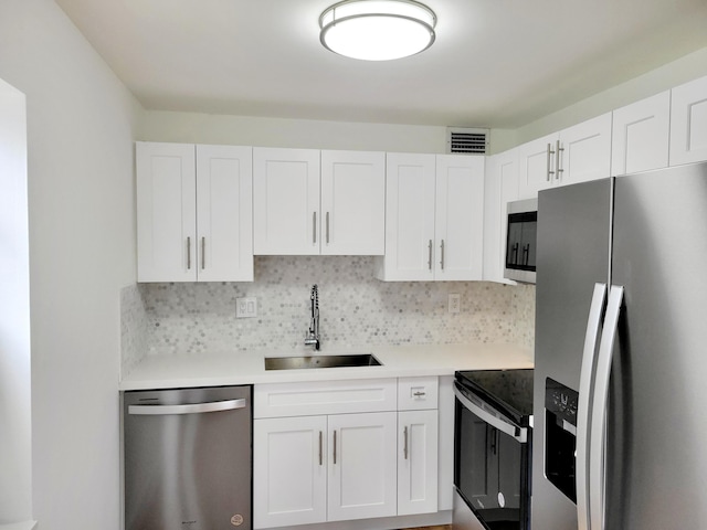 15 Burgundy Unit A, Delray Beach, FL 33484 - kitchen featuring white cabinets, light countertops, appliances with stainless steel finishes, and a sink
