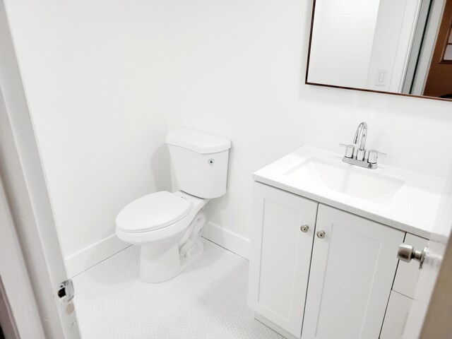 15 Burgundy Unit A, Delray Beach, FL 33484 - half bath featuring toilet, baseboards, vanity, and tile patterned flooring