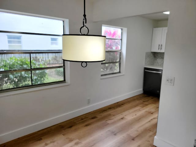 unfurnished dining area featuring light hardwood / wood-style flooring