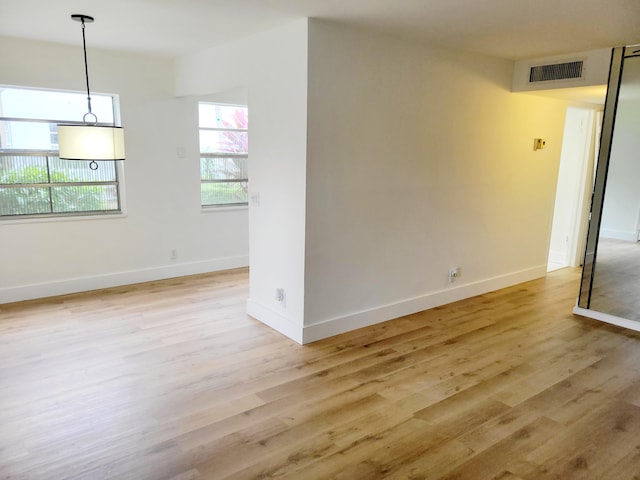 unfurnished room with light hardwood / wood-style floors