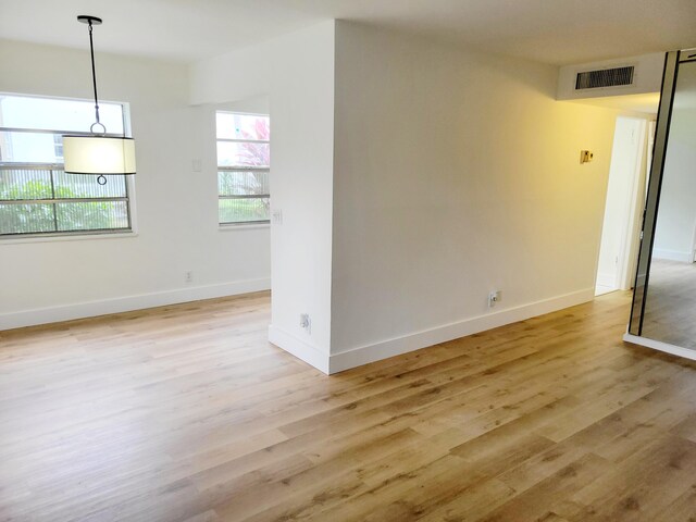 15 Burgundy Unit A, Delray Beach, FL 33484 - spare room featuring light wood-type flooring, visible vents, and baseboards