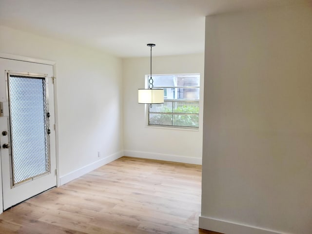 unfurnished dining area with light hardwood / wood-style floors