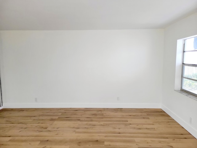 15 Burgundy Unit A, Delray Beach, FL 33484 - spare room featuring baseboards and light wood finished floors