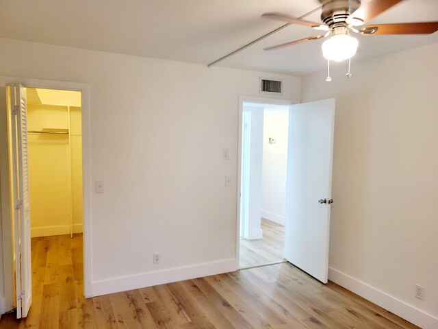15 Burgundy Unit A, Delray Beach, FL 33484 - unfurnished bedroom with a closet, baseboards, visible vents, a spacious closet, and light wood-type flooring