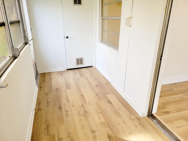 15 Burgundy Unit A, Delray Beach, FL 33484 - hall featuring light wood-style flooring, baseboards, and visible vents