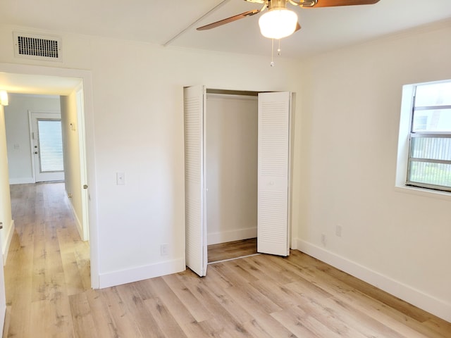 unfurnished bedroom with ornamental molding, light wood-type flooring, and ceiling fan