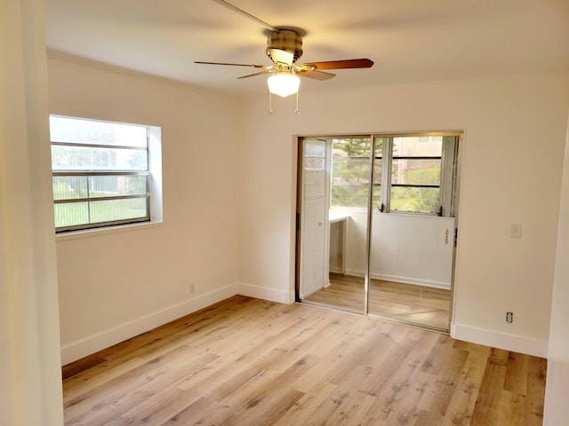 15 Burgundy Unit A, Delray Beach, FL 33484 - unfurnished bedroom featuring ceiling fan, light wood-style flooring, a closet, and baseboards
