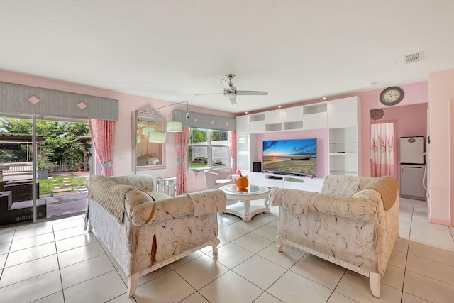 tiled living room featuring ceiling fan