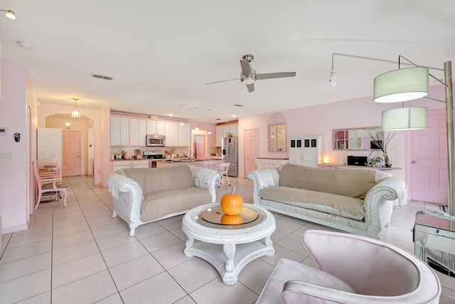 living room featuring light tile patterned flooring and ceiling fan