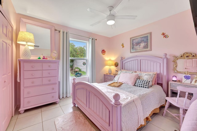 bedroom with ceiling fan, a closet, and light tile patterned floors