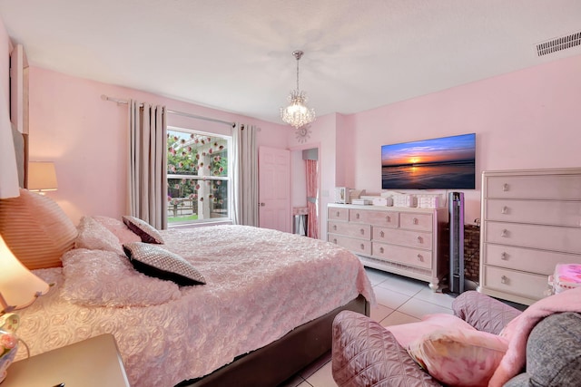 bedroom featuring a chandelier and light tile patterned floors