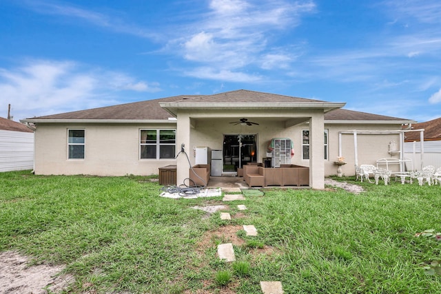 back of property with an outdoor hangout area, a yard, ceiling fan, and a patio area