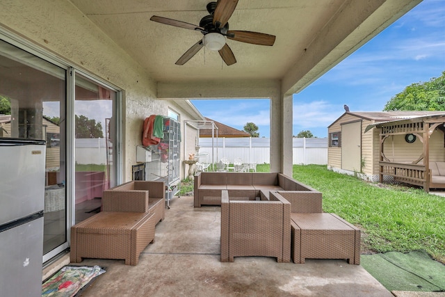 view of patio featuring outdoor lounge area, a shed, and ceiling fan