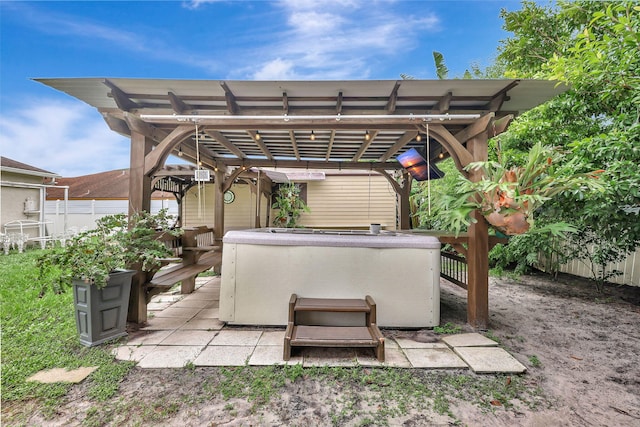 view of patio / terrace with a pergola, a deck, and a hot tub